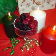 Berries and Christmas Candles photo of dish of raspberries and blackberries with Christmas holiday candles and ribbons