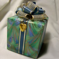 Birthday Present photo of blue and green wrapped package with bow and heart pendant