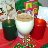 Egg Nog with Christmas Candles photo of egg nog with christmas candles ribbons and holiday decor