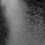 Raindrops Ripples and Bubbles photo of raindrops falling on wet pavement with ripples and bubbles
