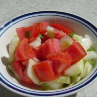 Photo of a bowl of tomato and cucumber salad