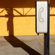 public telephone with shadow Free photo of a public telephone mini booth
