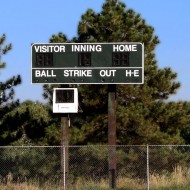 Free photo of a baseball scoreboard with pine trees in the background Free photo of a baseball scoreboard with pine trees in the background