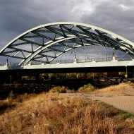 Free high resolution photo of an arch bridge with a cloudy sky in the background