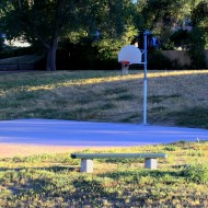 free high resolution picture of an empty park bench and basketball court