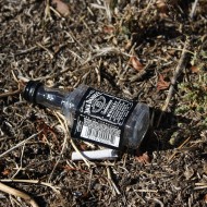 free photo of a Jack Daniels bottle tossed on the ground with cigarette butt free photo of a Jack Daniels bottle tossed on the ground with cigarette butt