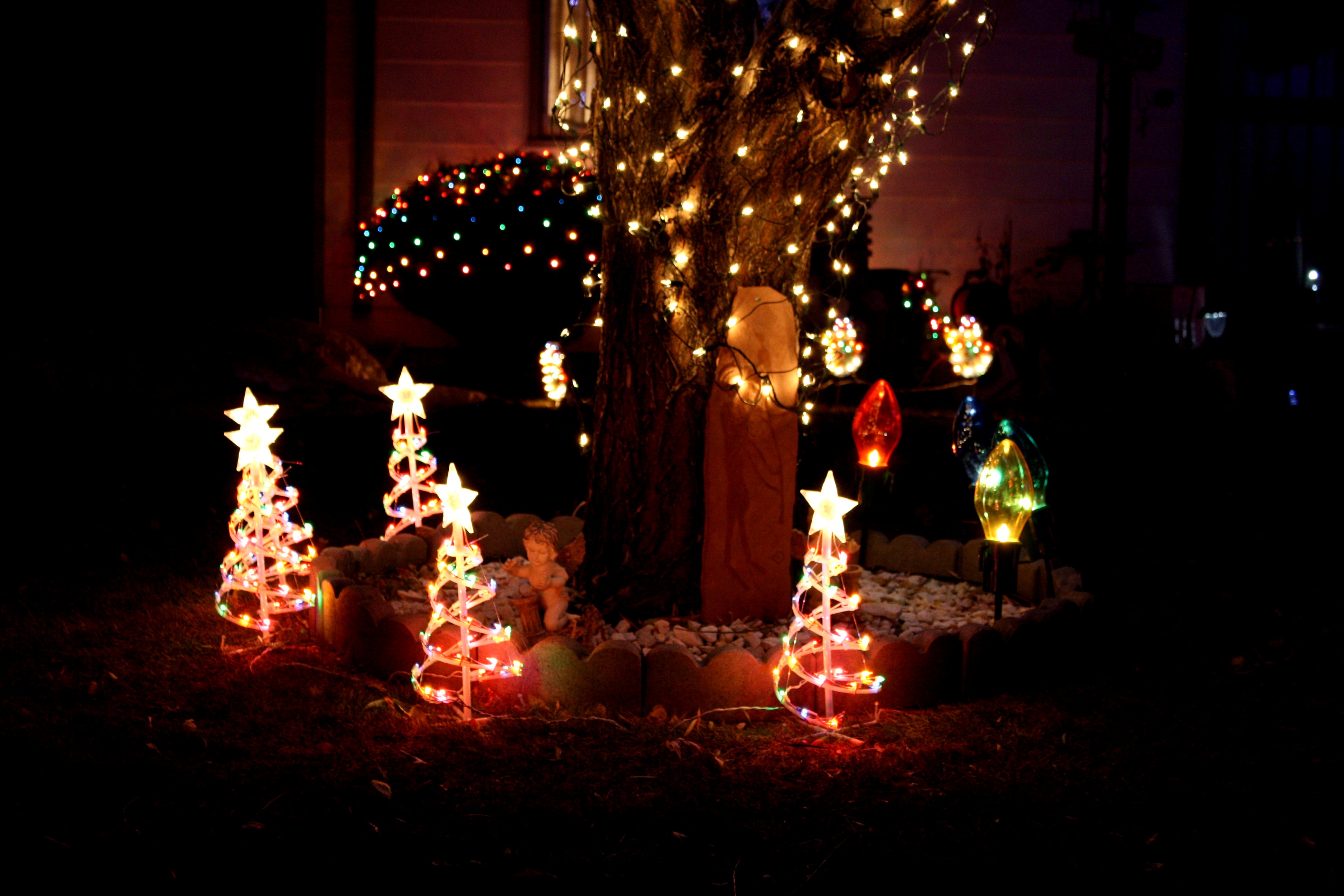 lighted Christmas yard decorations at night including spiral Christmas ...