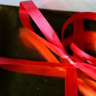 Gold Package with Red Ribbon - Free High Resolution Closeup Photo Gold Package with Red Ribbon - Free High Resolution Closeup Photo