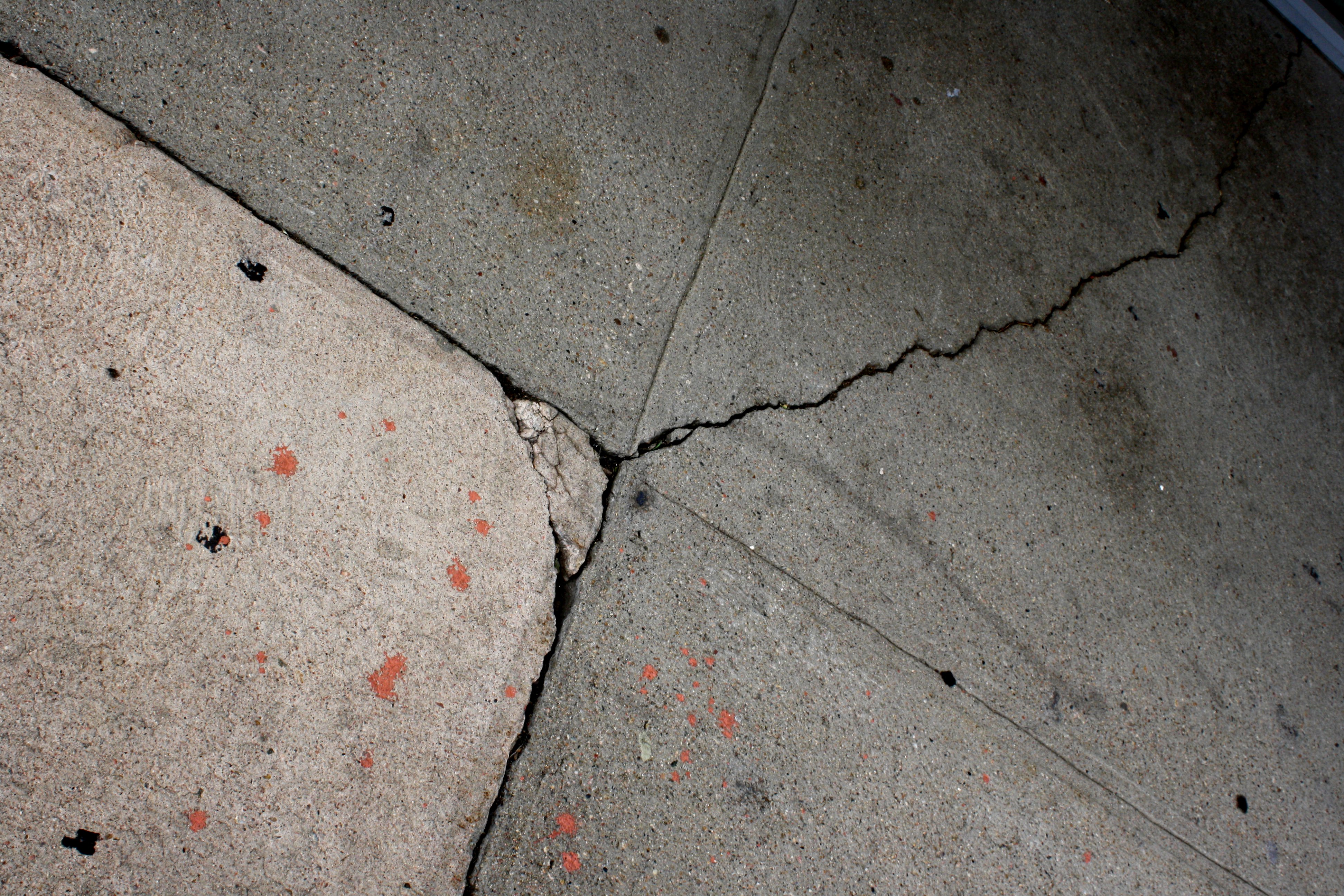 Cement Sidewalk with Cracks and Paint Splatters Picture | Free