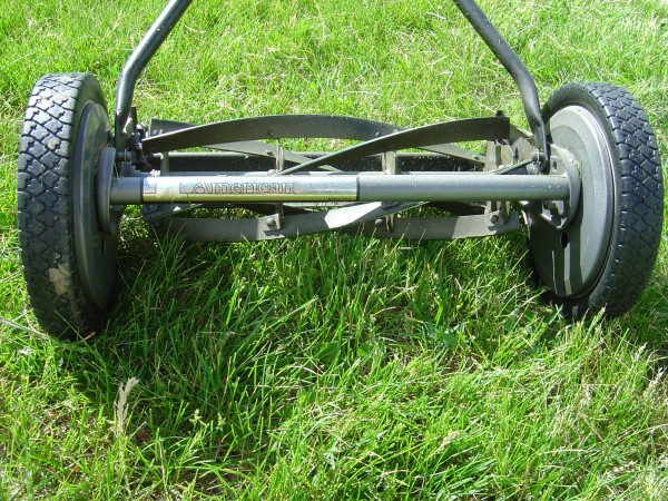 photo of hand push reel lawn mower in grass