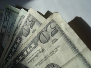 money photo of several fifty dollar bills