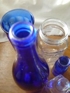 photo of cobalt blue bottles with clear glass jars taken from above