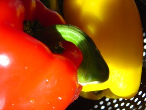 closeup photo of red and yellow bell peppers