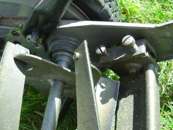 closeup photo of push reel lawn mower blades showing adjustment screws