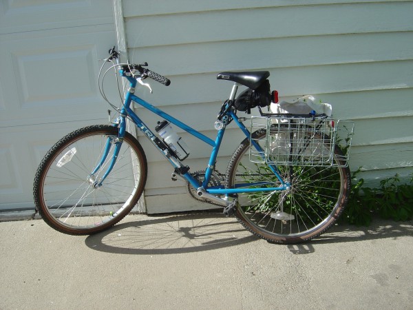 photo of blue bicycle with rear bike baskets