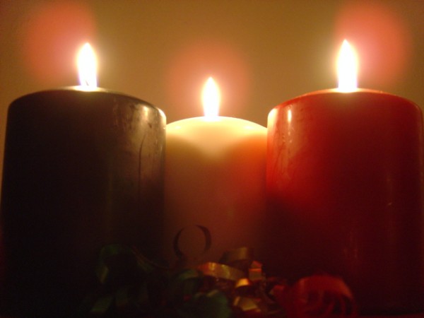 photo of three green white and red burning holiday christmas candles