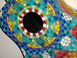 photo of guitar painted to look like colored Mexican tiles