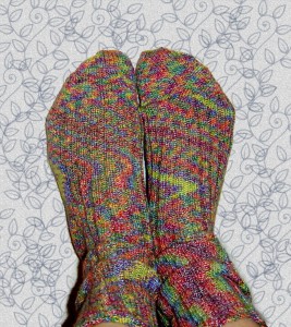 phot of two feet wearing brightly colored pair of socks