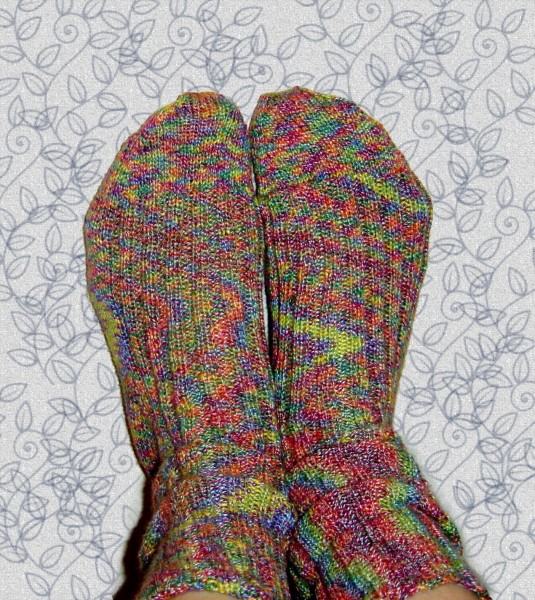photo of two feet wearing brightly colored pair of socks
