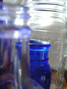 photo of clear and cobalt blue glass bottles and jars