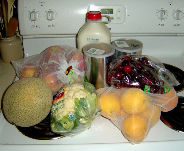 fruit milk vegetables and other groceries sitting on the stove