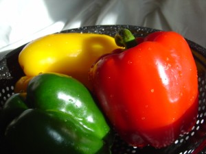 photo of three red yellow and green stoplight bell peppers