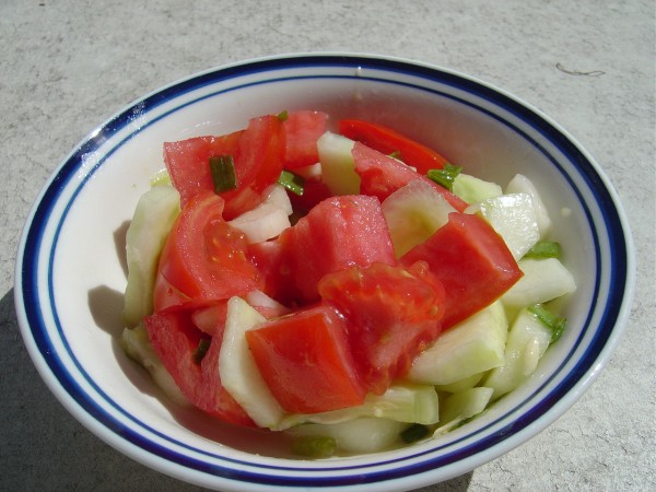 Photo of a bowl of tomato and cucumber salad