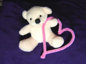 Photo of White Teddy bear holding a pink heart