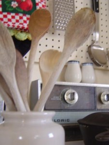 photo of kitchen with wooden spoons stove and salt and pepper shakers