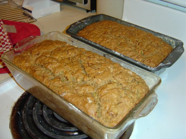 Two loaves of zucchini bread cooling on the stove top