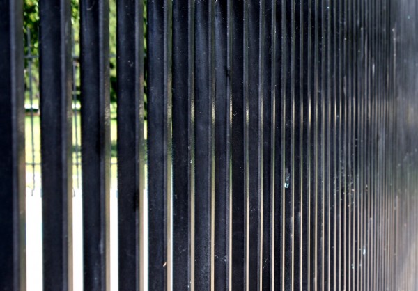 photo looking along the edge of a black security fence
