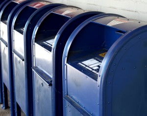 Free photo of a row of blue USPS mail boxes