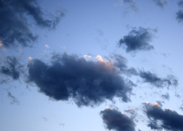 free photograph of dark wispy clouds in a blue sky