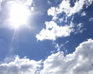 free photograph of the sun shining in a beautiful blue sky with white clouds