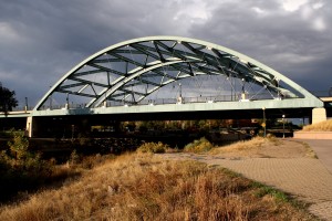 Free high resolution photo of an arch bridge with a cloudy sky in the background