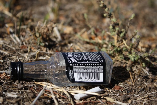 Free high resolution photo of an empty Jack Daniels Whisky bottle on the ground