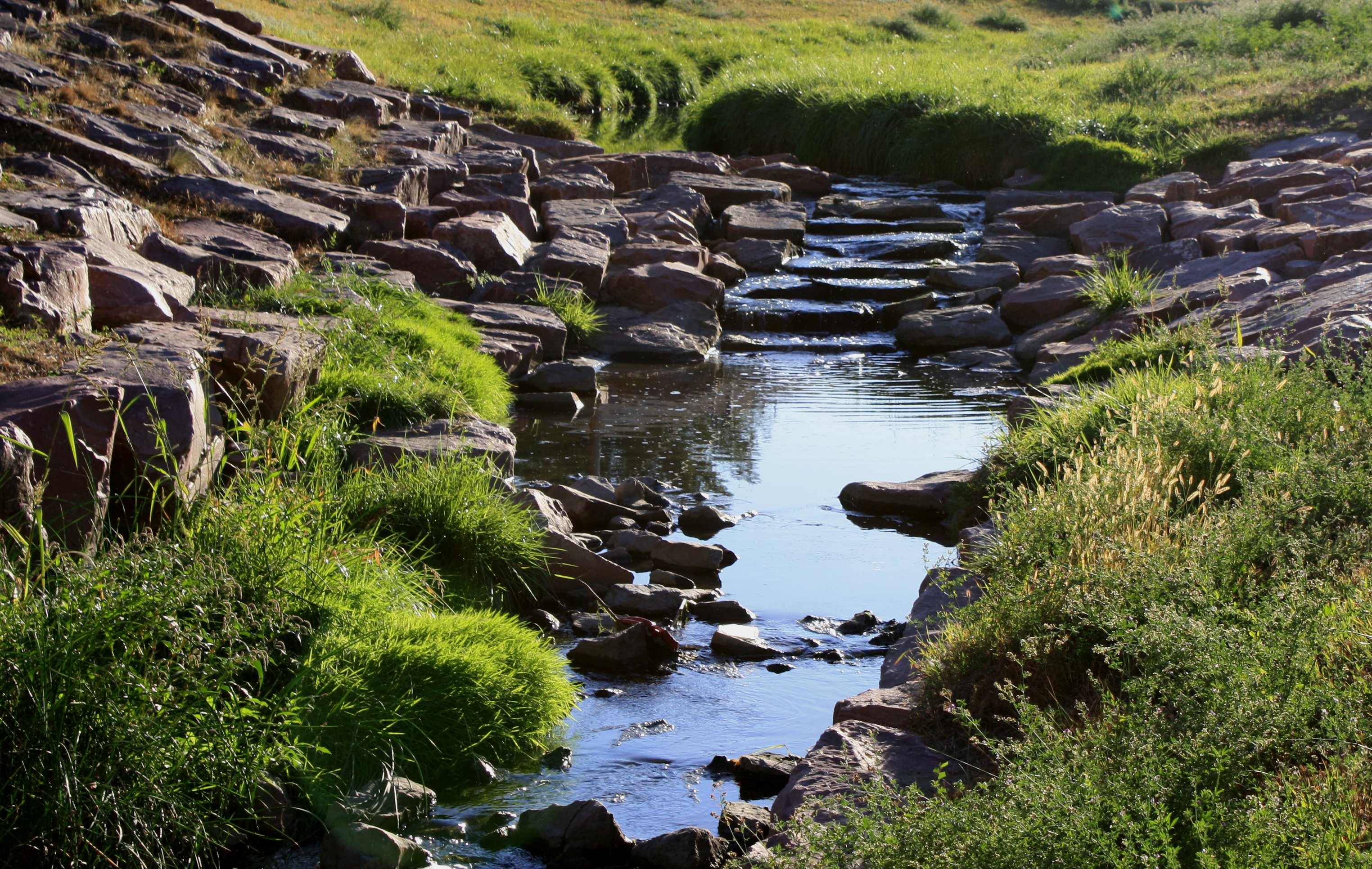 Stream with Waterfall Free photo of a small stream flowing over a small rock waterfall