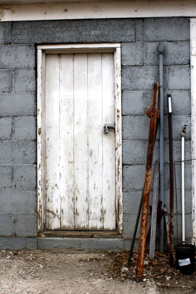 Old Shed Door with Metal Stakes Leaning Next to it - Free High Resolution Photo