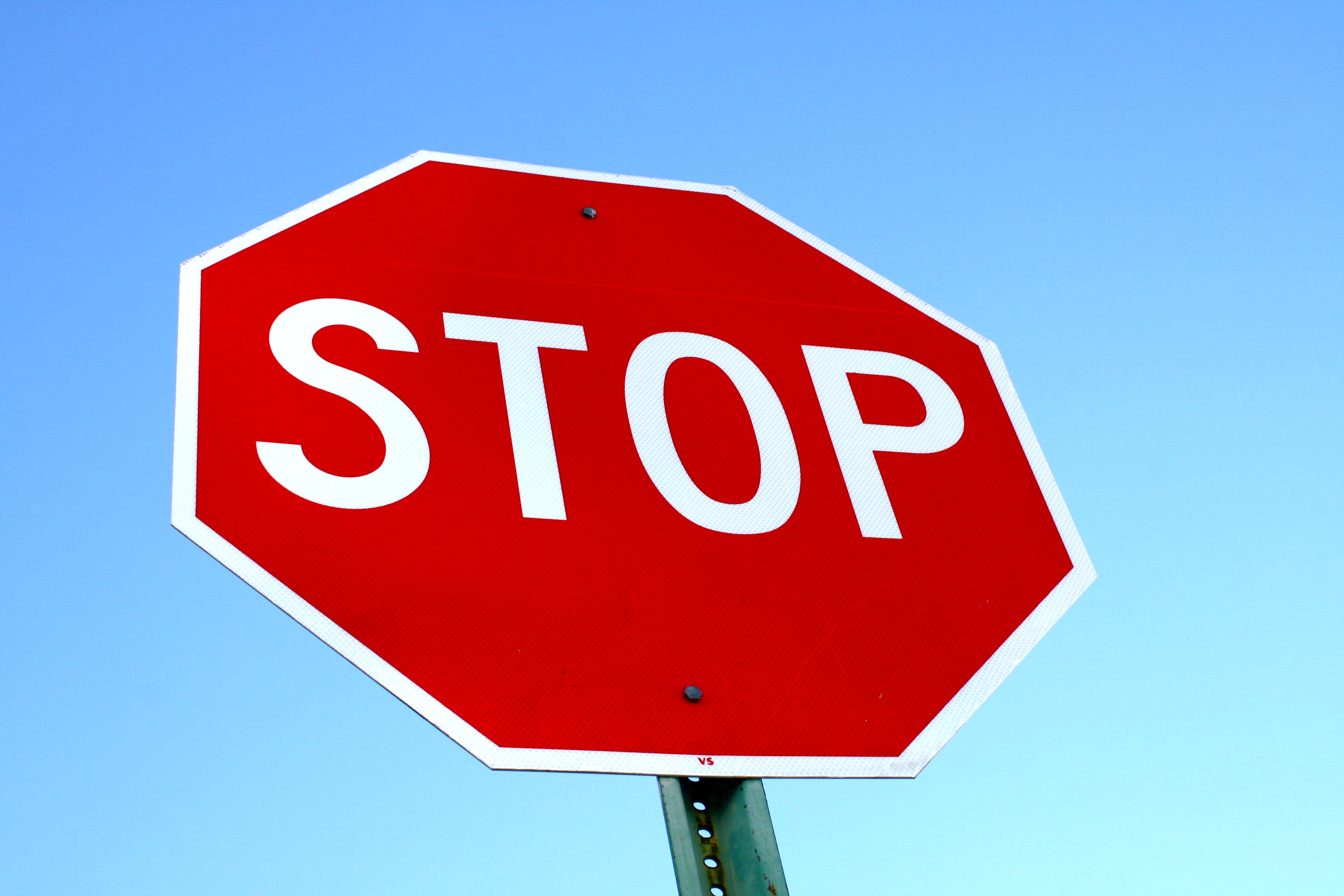 stop sign with blue sky background ponder your financial future with healthier 4u vending