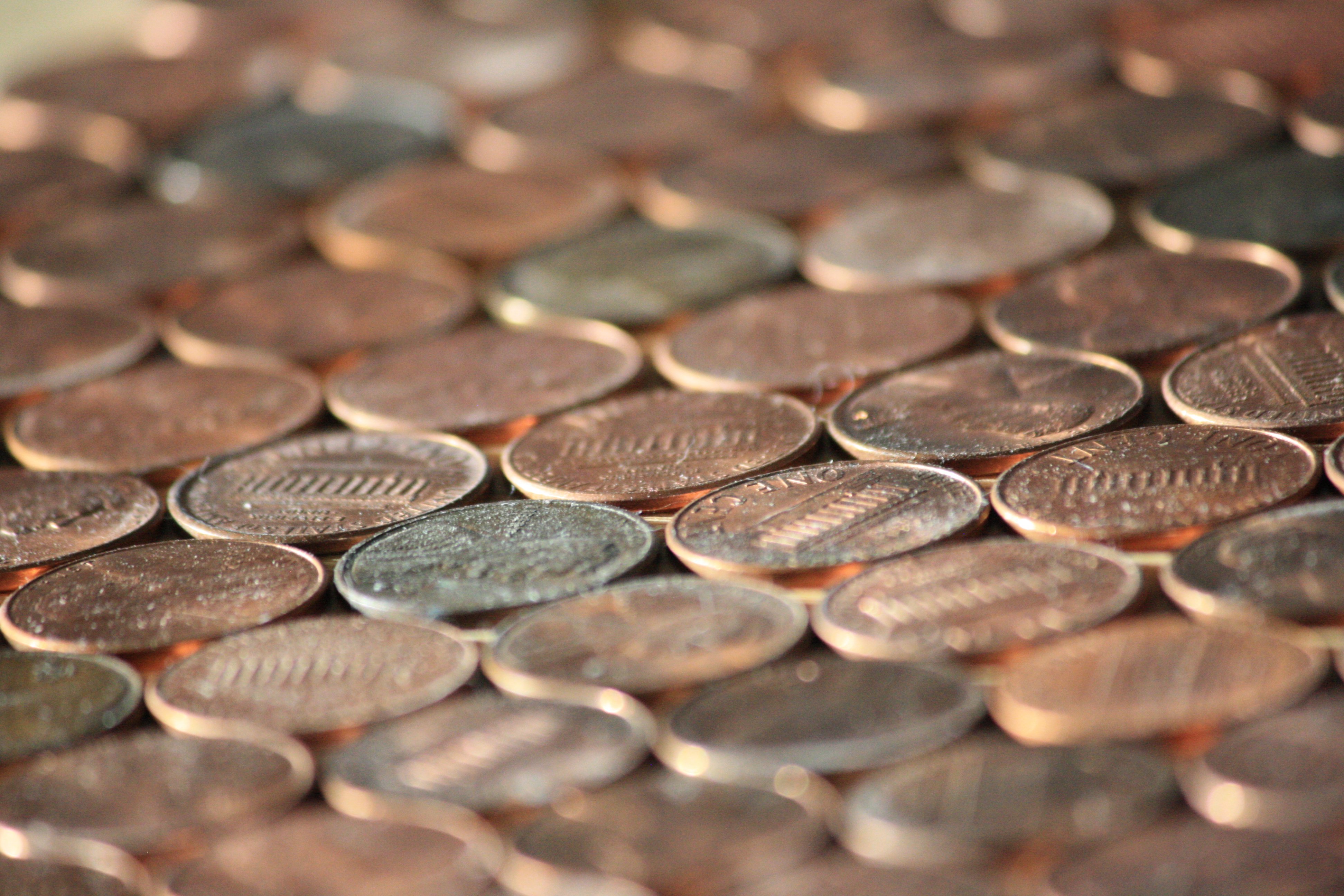 This close up picture shows US Lincoln pennies some heads and some tails. 
