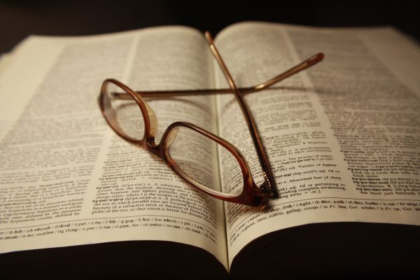 Reading Glasses atop Pages of Open Dictionary Book - Free High Resolution Photo